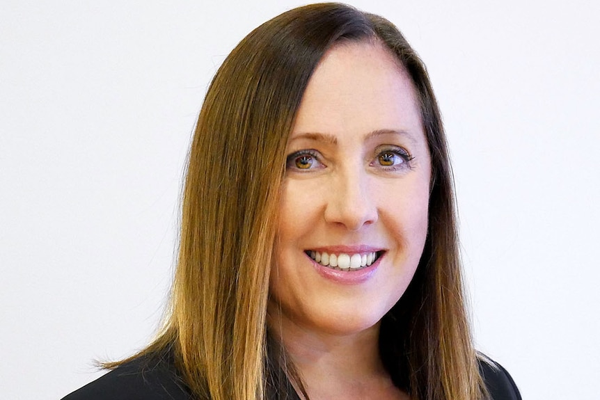 A portrait photo of a woman smiling.