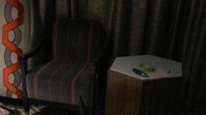 A chair is seen in Stephen Paddock's hotel room next to a small table with a piece of paper and a pen.