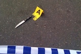 A knife is cordoned off by police at a crime scene
