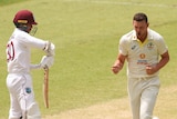 Australia bowler Josh Hazlewood runs past West Indies batter Tagenarine Chanderpaul after taking his wicket in a Test in Perth.