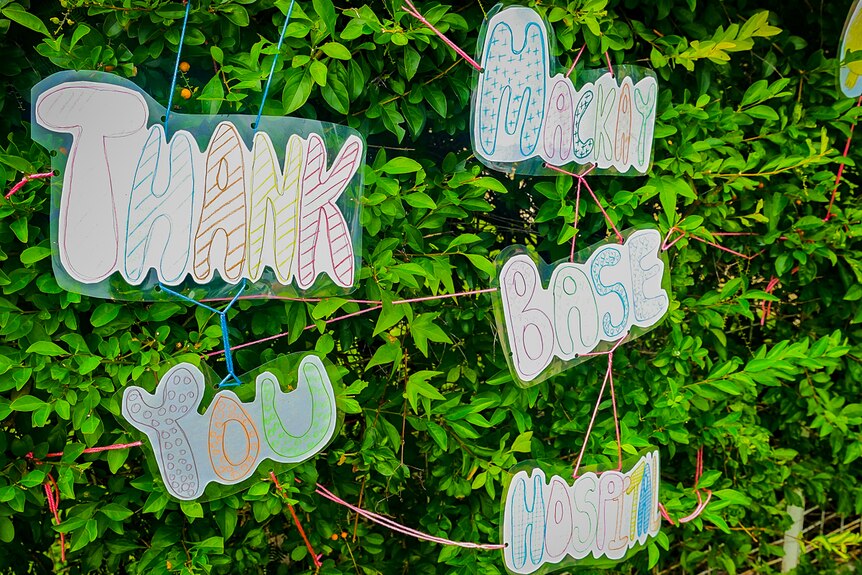 hand drawn thank you sign on hedge