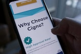 Hand holding a mobile phone with the Cigno app showing words: Why choose Cigno?