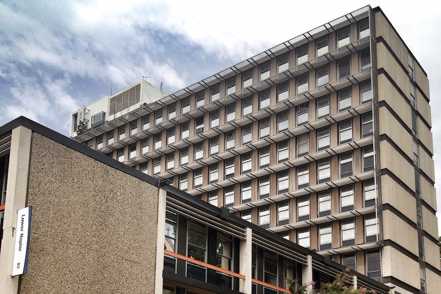 An office building with a sculpture in front