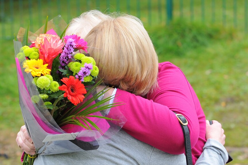 Two women hug outside Pontardawe Community Centre