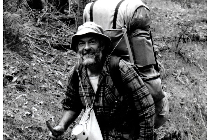 A man in hiking gear on a bush path.