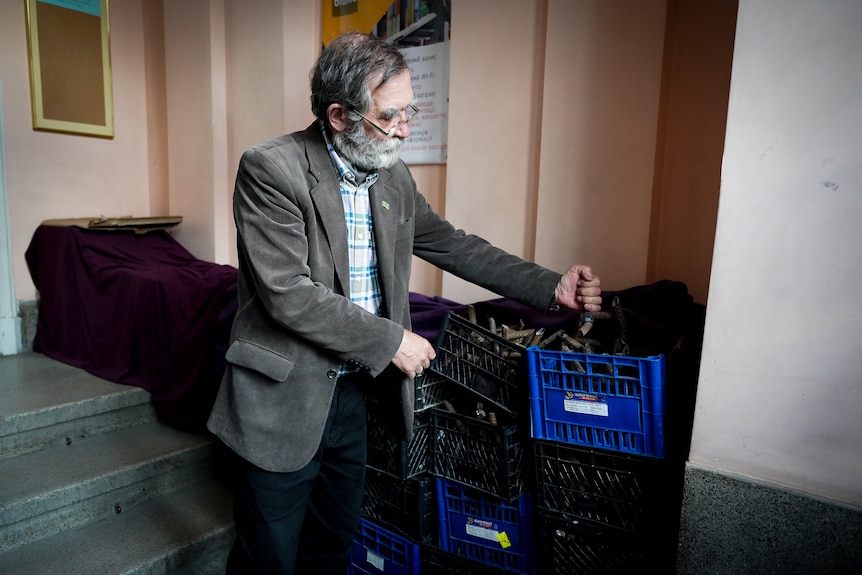 Ivan Svarnyk uncovers the stack of metal vehicle traps near the library door. 