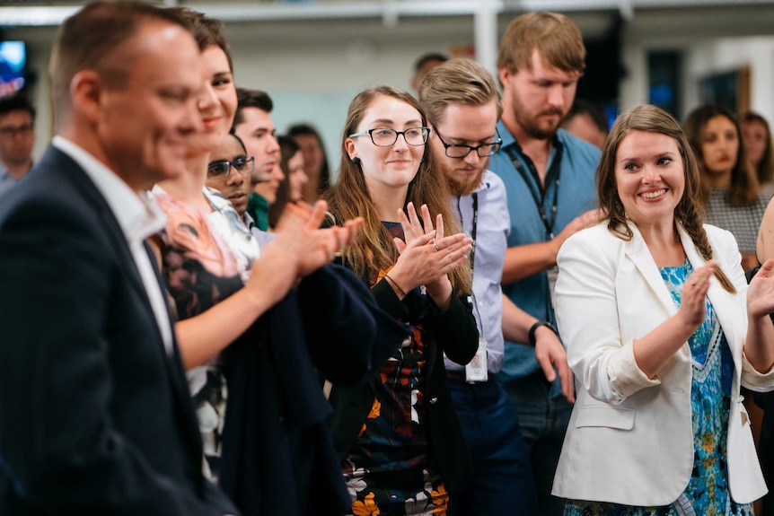 Stuart Watt and his Digital team celebrate 20 years at a party in the newsroom.