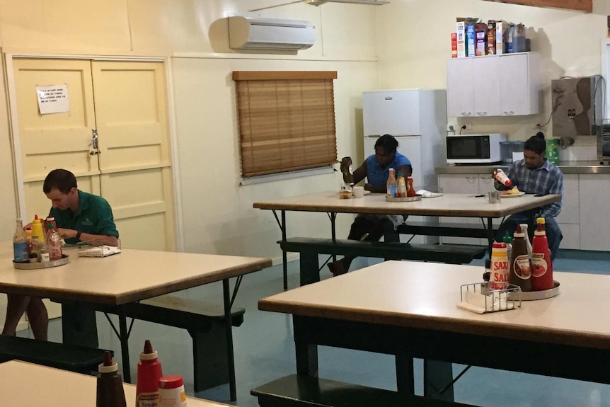 people sit down for dinner far apart