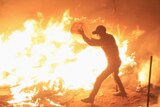 Egyptian protester extinguishes flaming tent