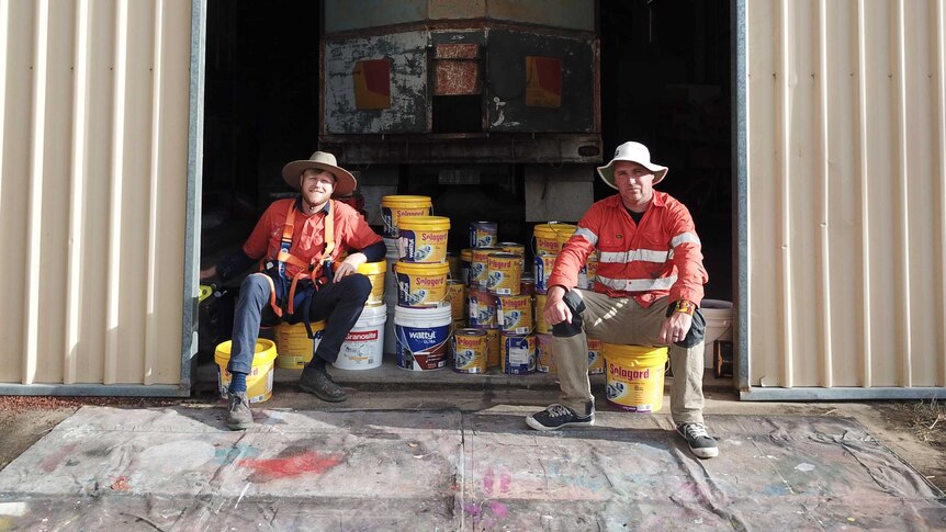 Artists' Zookeeper and Drapl sitting on paint tins