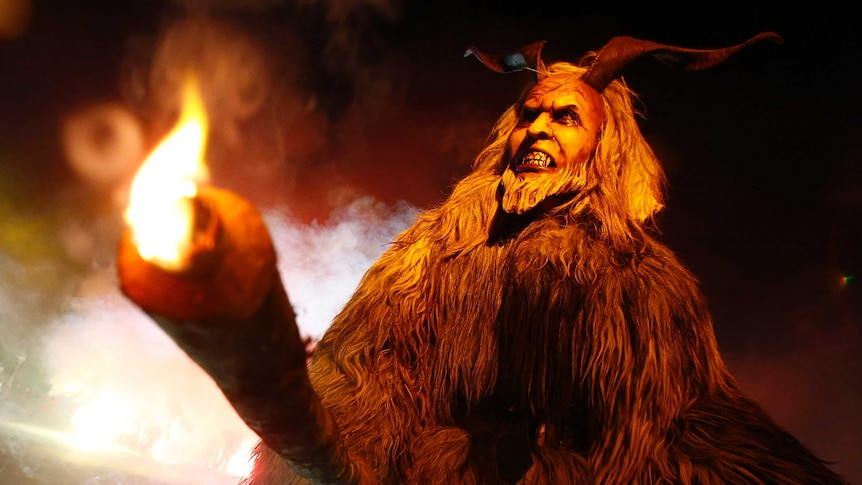 A man dressed in  Perchten costume and mask performs during a Perchten festival in the western Austrian village of Heitwerwang.