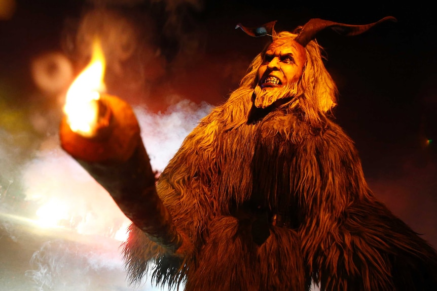 A man dressed in  Perchten costume and mask performs during a Perchten festival in the western Austrian village of Heitwerwang.