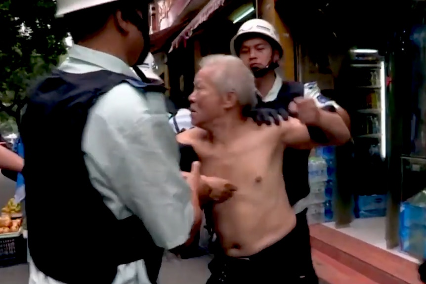 Still from movie 'City Dream', showing chengguan clashing with street vendors outside