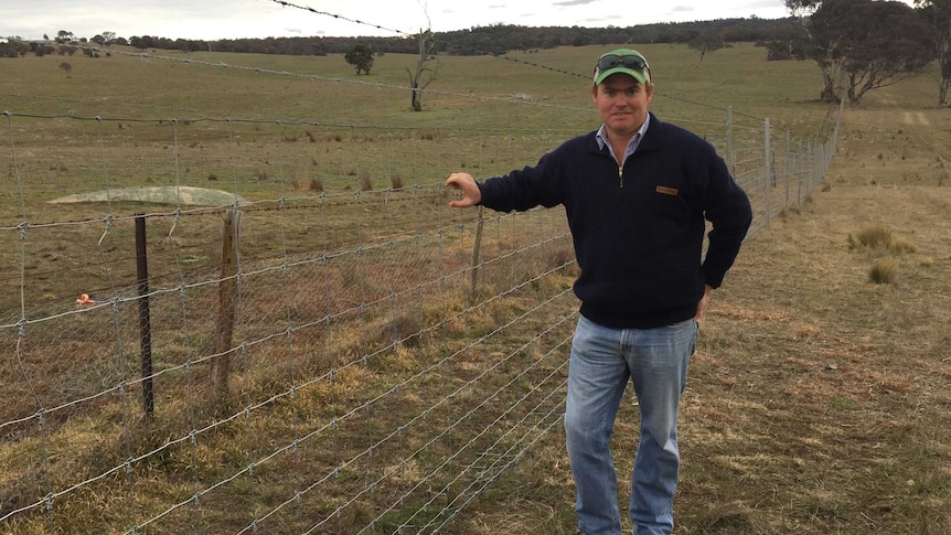 jack glasson in front of his new fence