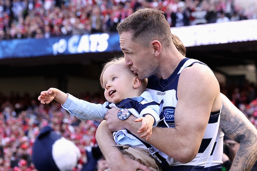 Joel Selwood kiss Levi Ablett on the head as he walks onto the MCG