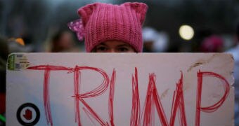 A protestor at the Women's March holds a sign with Donald Trump's name on it.
