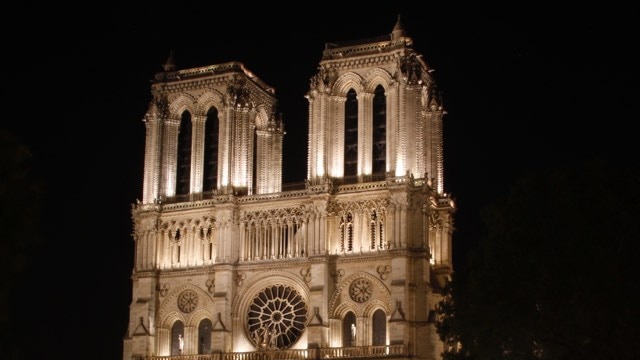 The two Notre Dame cathedral towers lit up at night.