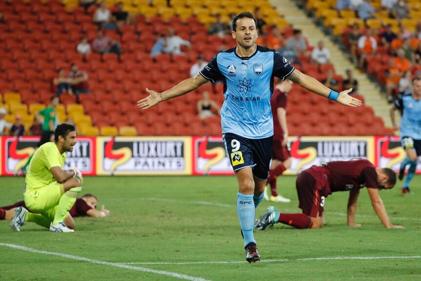 Bobo runs with his arms spread out after scoring for Sydney FC against Brisbane Roar.