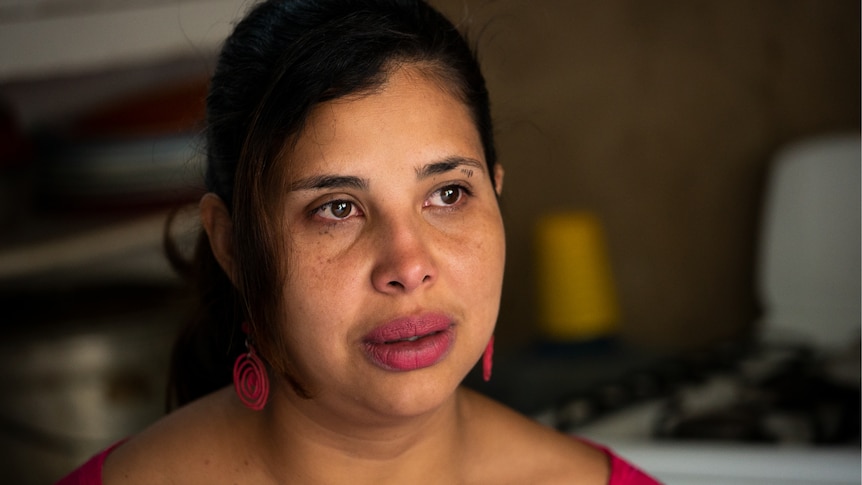 A Venezuelan woman looking off into the distance with a pensive expression