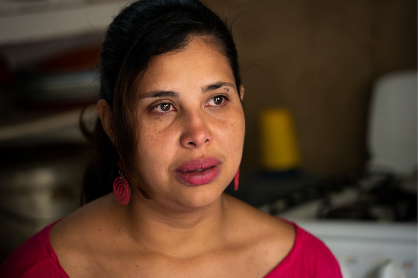 A Venezuelan woman looking off into the distance with a pensive expression