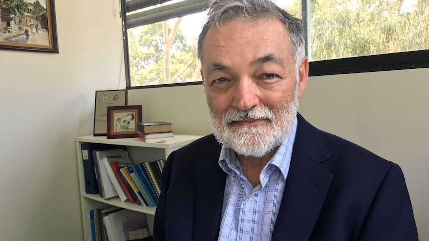 man in office looking into camera