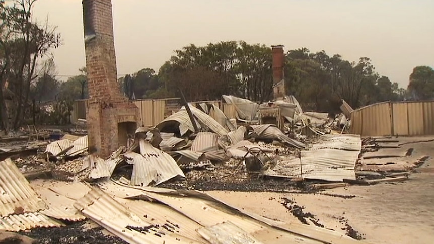 Sheet metal and the rubble of destroyed buildings on the ground in Yarloop after a bushfire.
