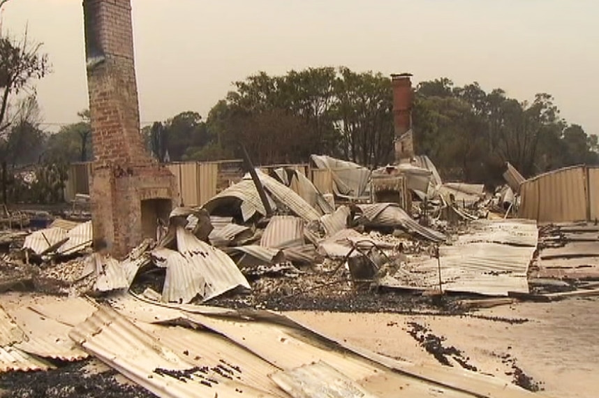 Sheet metal and the rubble of destroyed buildings on the ground in Yarloop after a bushfire.