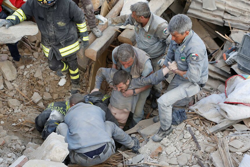 A man is rescued alive from the ruins following an earthquake in Amatrice, central Italy.
