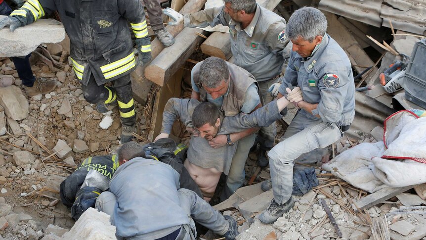 A man is rescued alive from the ruins following an earthquake in Amatrice, central Italy.