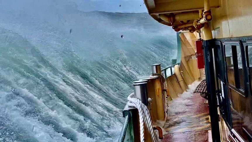 A Sydney ferry sails through wild waves.