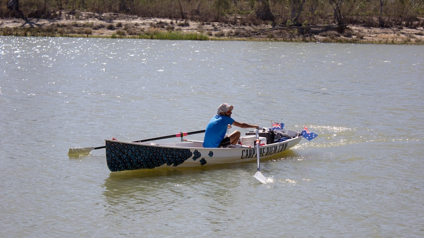 Daniel O'Callaghan rowing along River Murray in his handmade boat Carpeyediem
