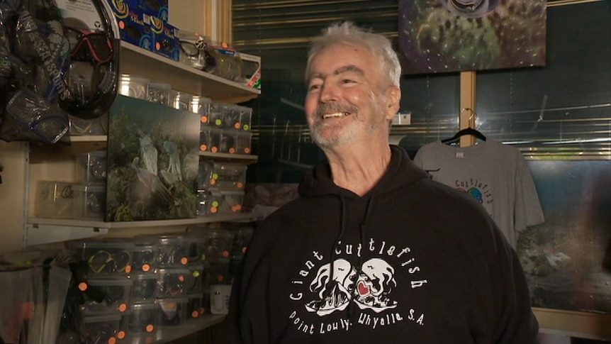 A smiling man at the front counter of his shop in Whyalla