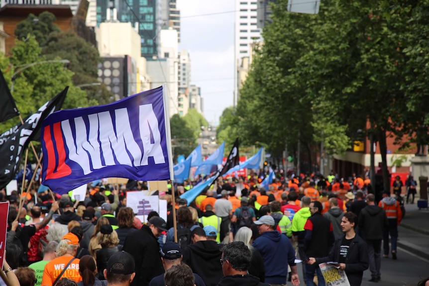 Protesters in the streets, with banners, flags and placards.