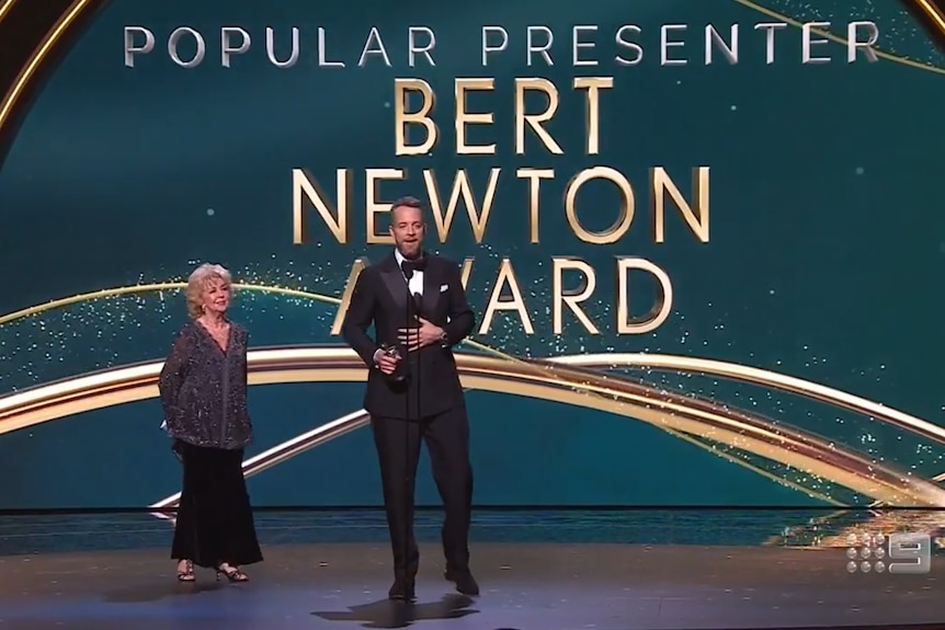 Patti Newton and Hamish Blake on stage at the 2022 Logie Awards