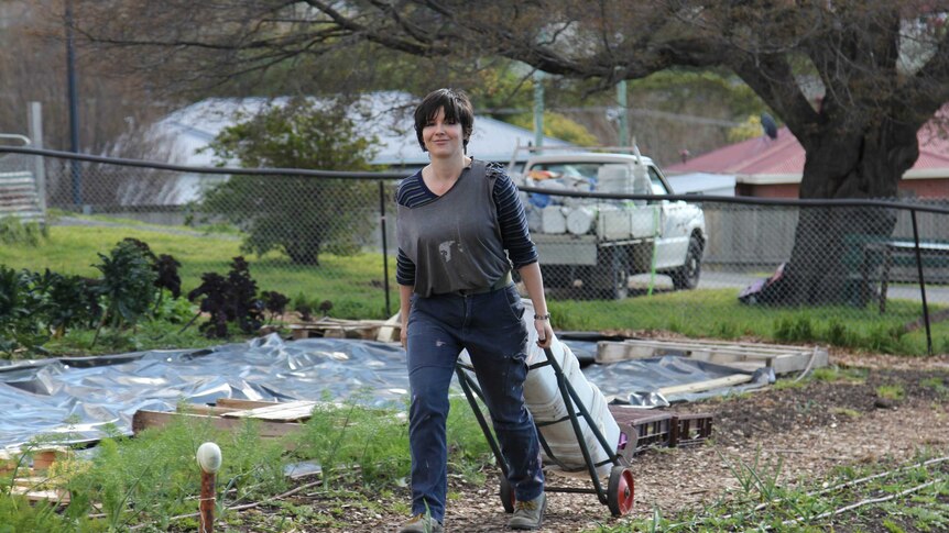 Gabriela Johnston wheeling some compost