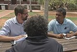 Lawyer, interpreter and Aboriginal client sitting outside Broome Court