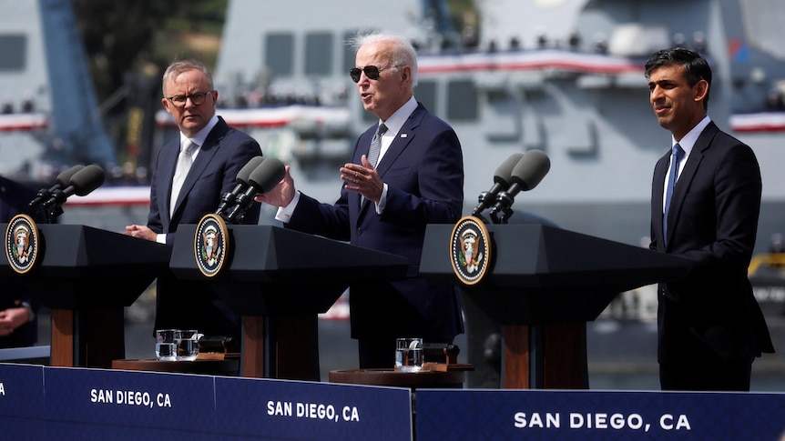 Anthony Albanese, Joe Biden and Rishi Sunak stand at lecterns at a US naval base in San Diego