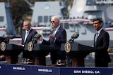 Anthony Albanese, Joe Biden and Rishi Sunak stand at lecturns at a US naval base in San Diego