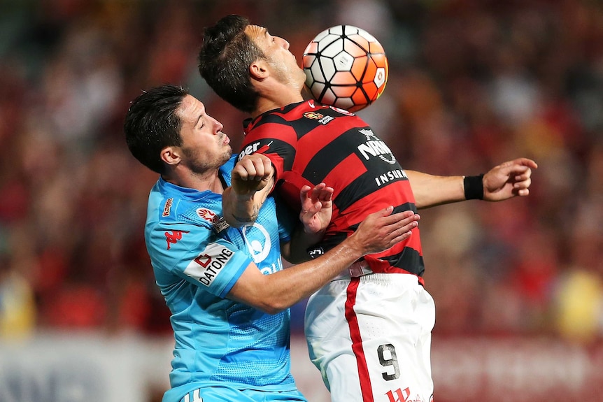 Federico Piovaccari of the Wanderers competes with Dylan McGowan of Adelaide