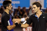Novak Djokovic and Roger Federer shake hands at the net at the 2008 Australian Open.