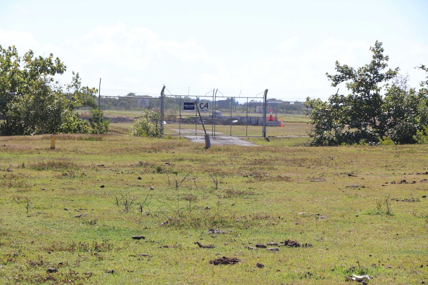 A field with a fence in the background