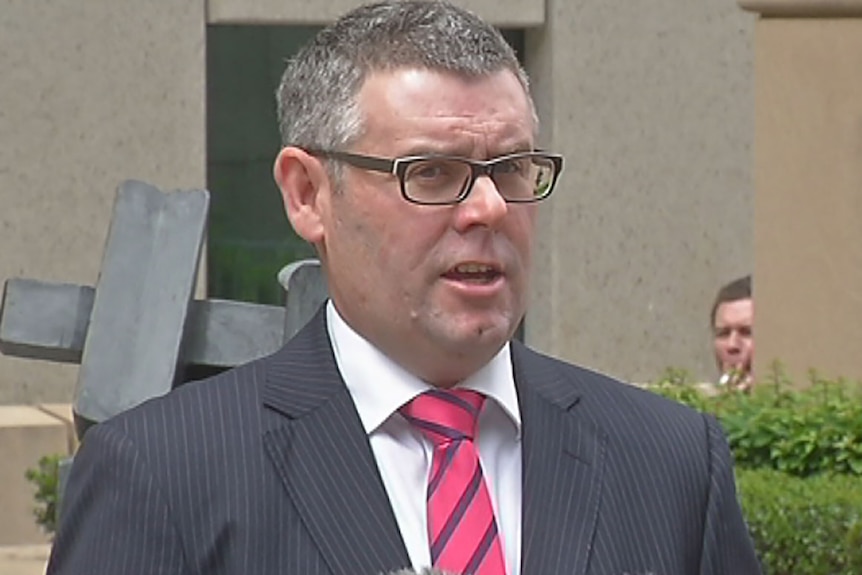 TV still of Murray Watt from Maurice Blackburn Lawyers, outside Brisbane court complex