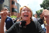 Venezuelan General Prosecutor Luisa Ortega Diaz speaks to the media, her hands are raised.
