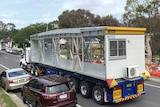 a truck with a demountable buildings on the back
