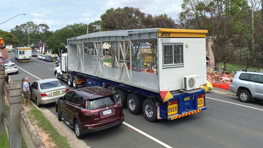 a truck with a demountable buildings on the back