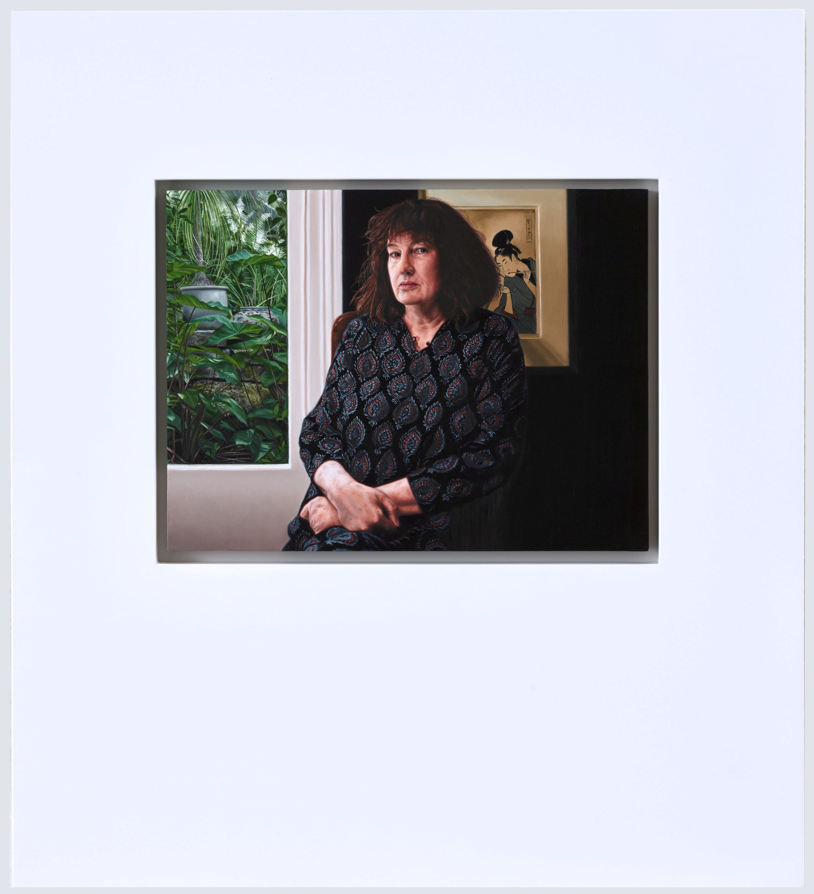 A painting of a woman with brown curly hair, sitting inside in front a window looking onto a gardenand a framed painting