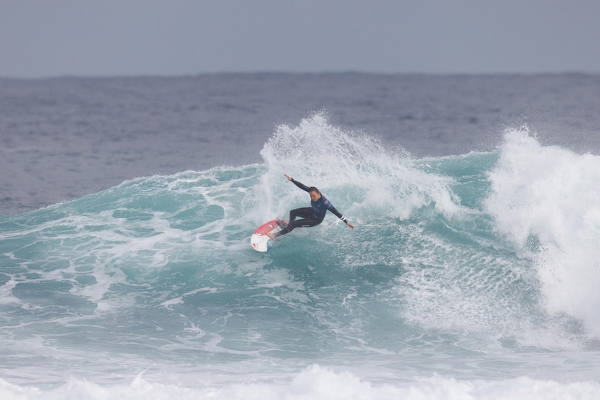 Carissa Moore doing a turn on a big wave