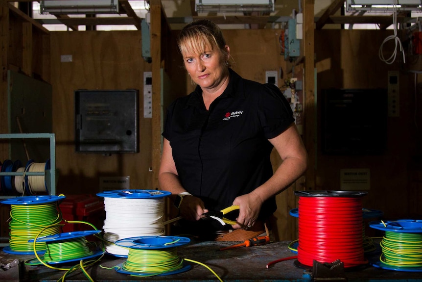 Jennifer Perkins surrounded by electrical wires