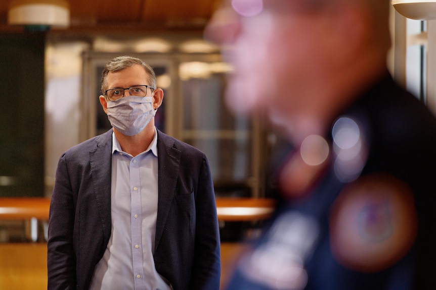 Michael Gunner watches on at a COVID press conference