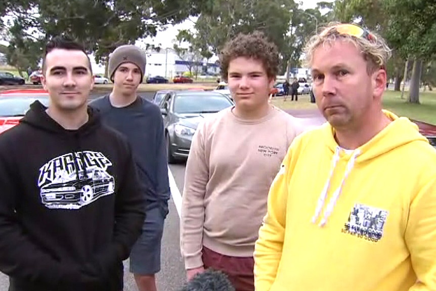 Hobart mechanic Christian Mason, his two sons and mate outside the Holden plant.